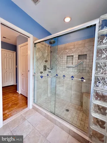 a bathroom with a glass shower door