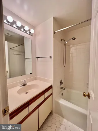 a bathroom with a sink bath tub and a mirror