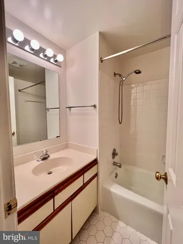 a bathroom with a sink bath tub and a mirror