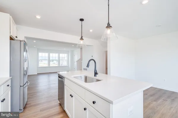 a kitchen with a sink and chandelier