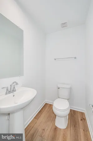 a white toilet sitting next to a bathroom sink