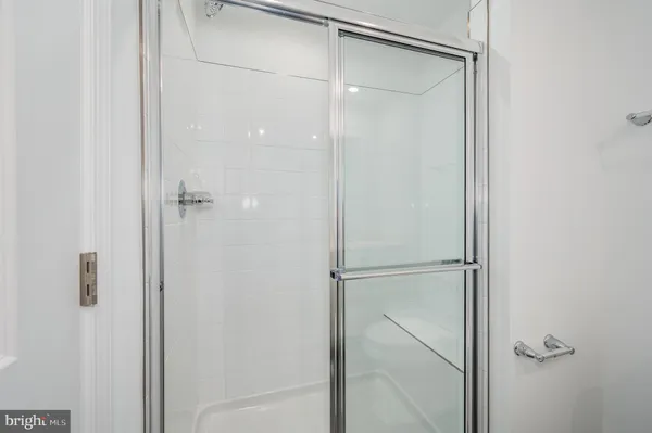 a bathroom with a glass shower door