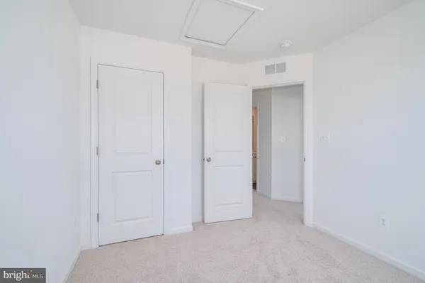 an empty room with closet area