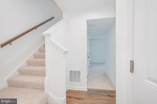 a view of staircase with white walls