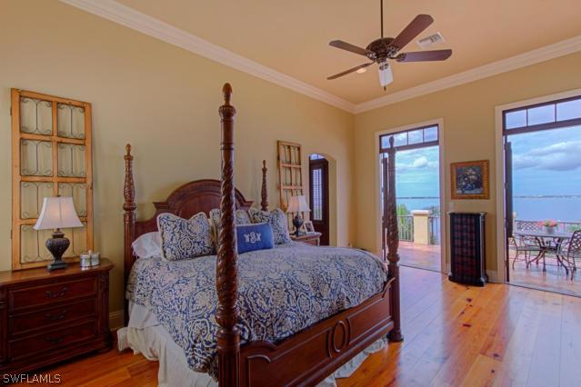 6005 West Riverside Drive Fort Myers, FL 33919 - Photo 12 of 24 a bed room with a bed and a chandelier