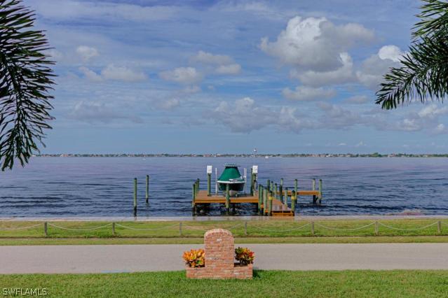 6005 West Riverside Drive Fort Myers, FL 33919 - Photo 19 of 24 a front view of a house with a garden and lake view