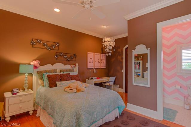 6005 West Riverside Drive Fort Myers, FL 33919 - Photo 21 of 24 a bedroom with a bed and wooden floor