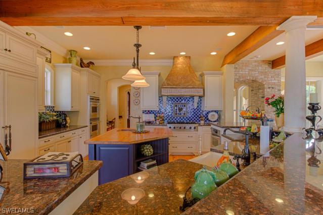 6005 West Riverside Drive Fort Myers, FL 33919 - Photo 6 of 24 a large kitchen with sink a counter and chairs