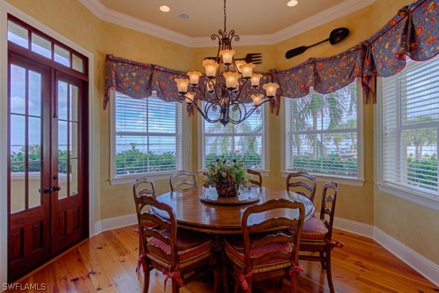 6005 West Riverside Drive Fort Myers, FL 33919 - Photo 7 of 24 a view of a dining room with furniture a chandelier and wooden floor