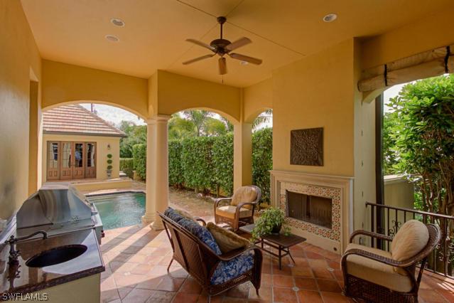 6005 West Riverside Drive Fort Myers, FL 33919 - Photo 9 of 24 a living room with furniture a fireplace and a floor to ceiling window
