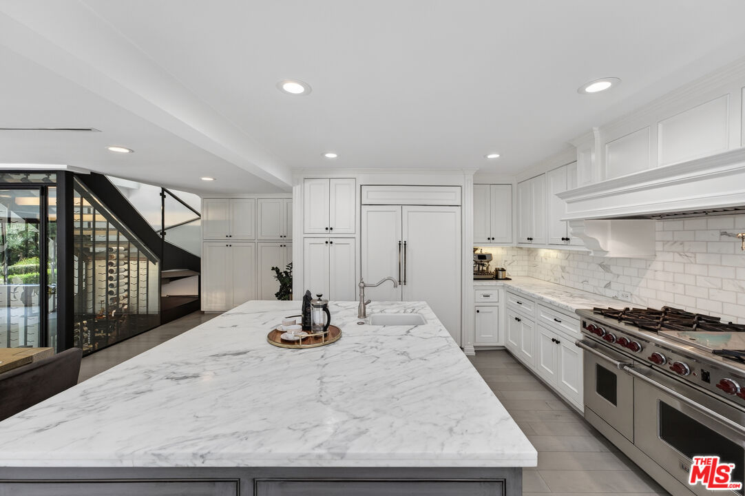 760 South San Rafael Avenue Pasadena, CA 91105 - Photo 23 of 45 a kitchen with stainless steel appliances kitchen island granite countertop a stove a sink and a refrigerator