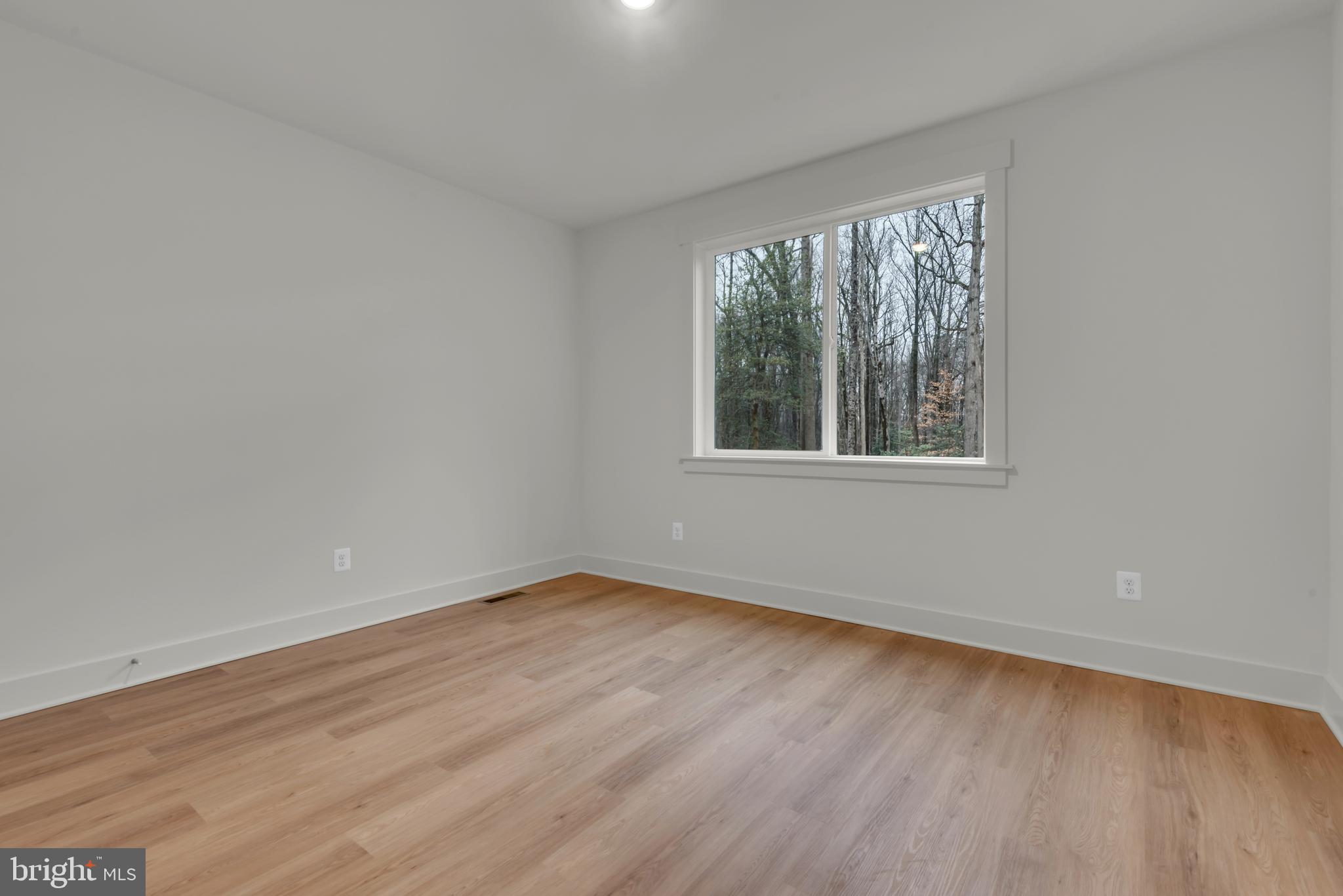 6502 Whitetail Xing Way Hanover, MD 21076 - Photo 16 of 58 a view of an empty room with wooden floor and a window