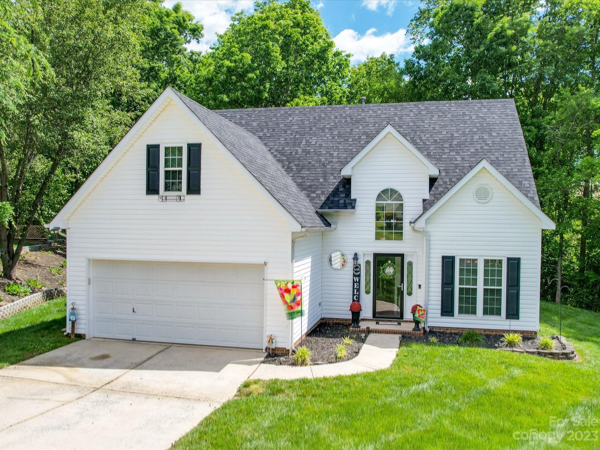 a aerial view of a house with a yard chairs and table