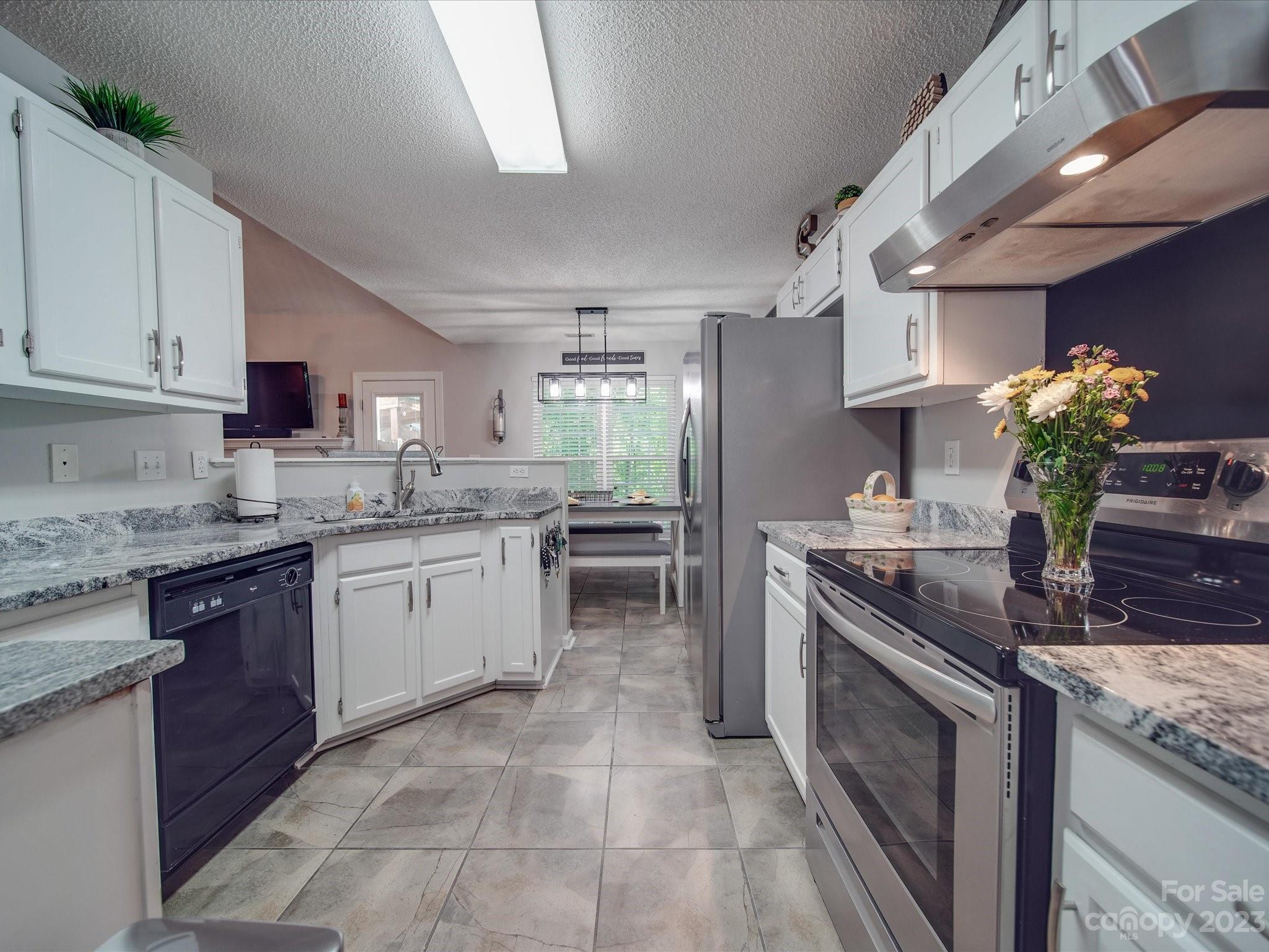 2349 Beaver Pond Road Kannapolis, NC 28083 - Photo 13 of 41 a kitchen with granite countertop a sink stove and cabinets