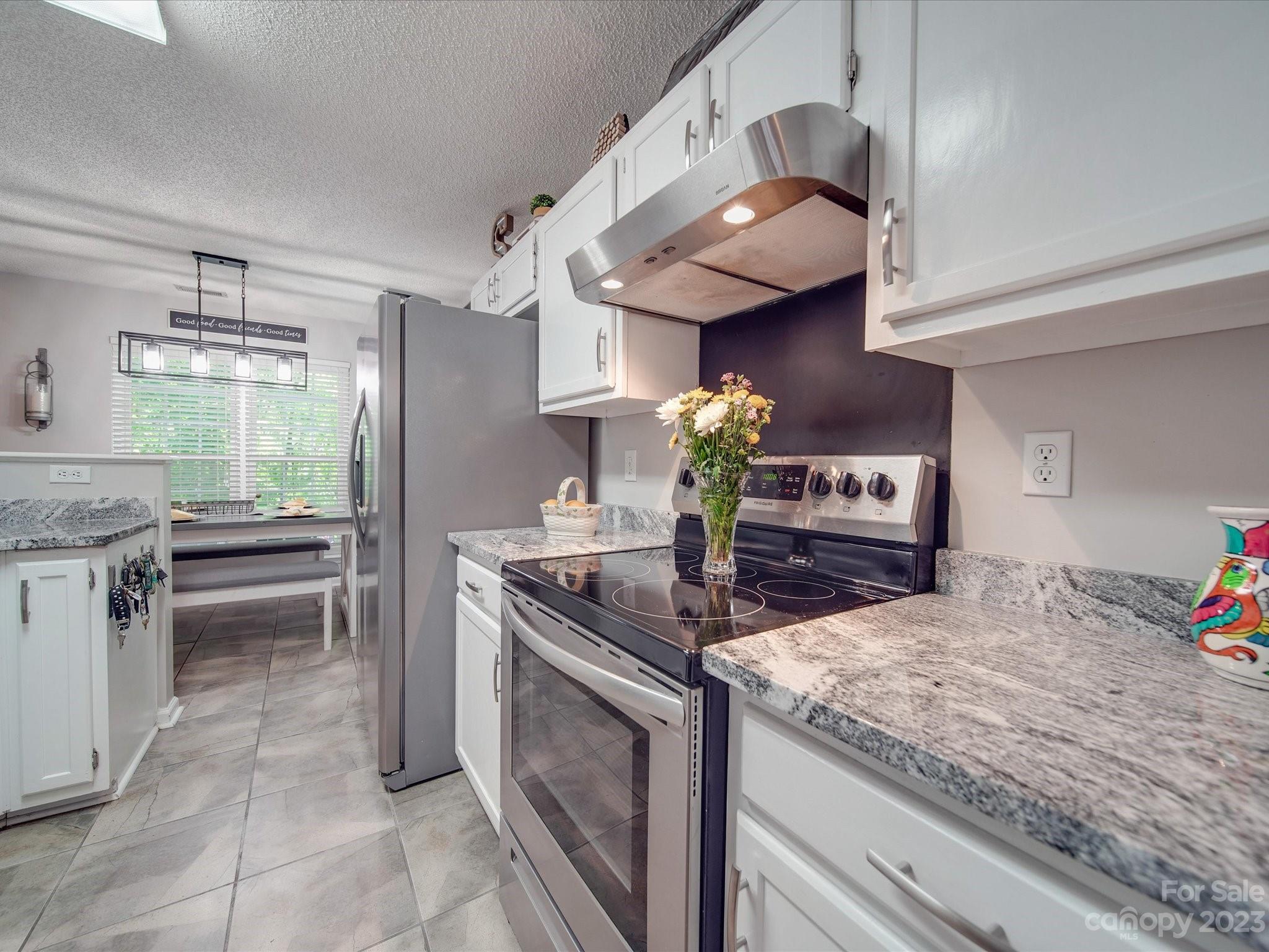 2349 Beaver Pond Road Kannapolis, NC 28083 - Photo 15 of 41 a kitchen with stainless steel appliances granite countertop a sink and a stove