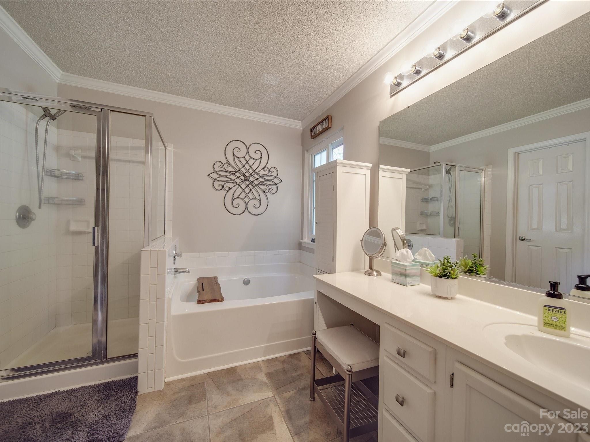 2349 Beaver Pond Road Kannapolis, NC 28083 - Photo 19 of 41 a bathroom with a tub a sink and a shower