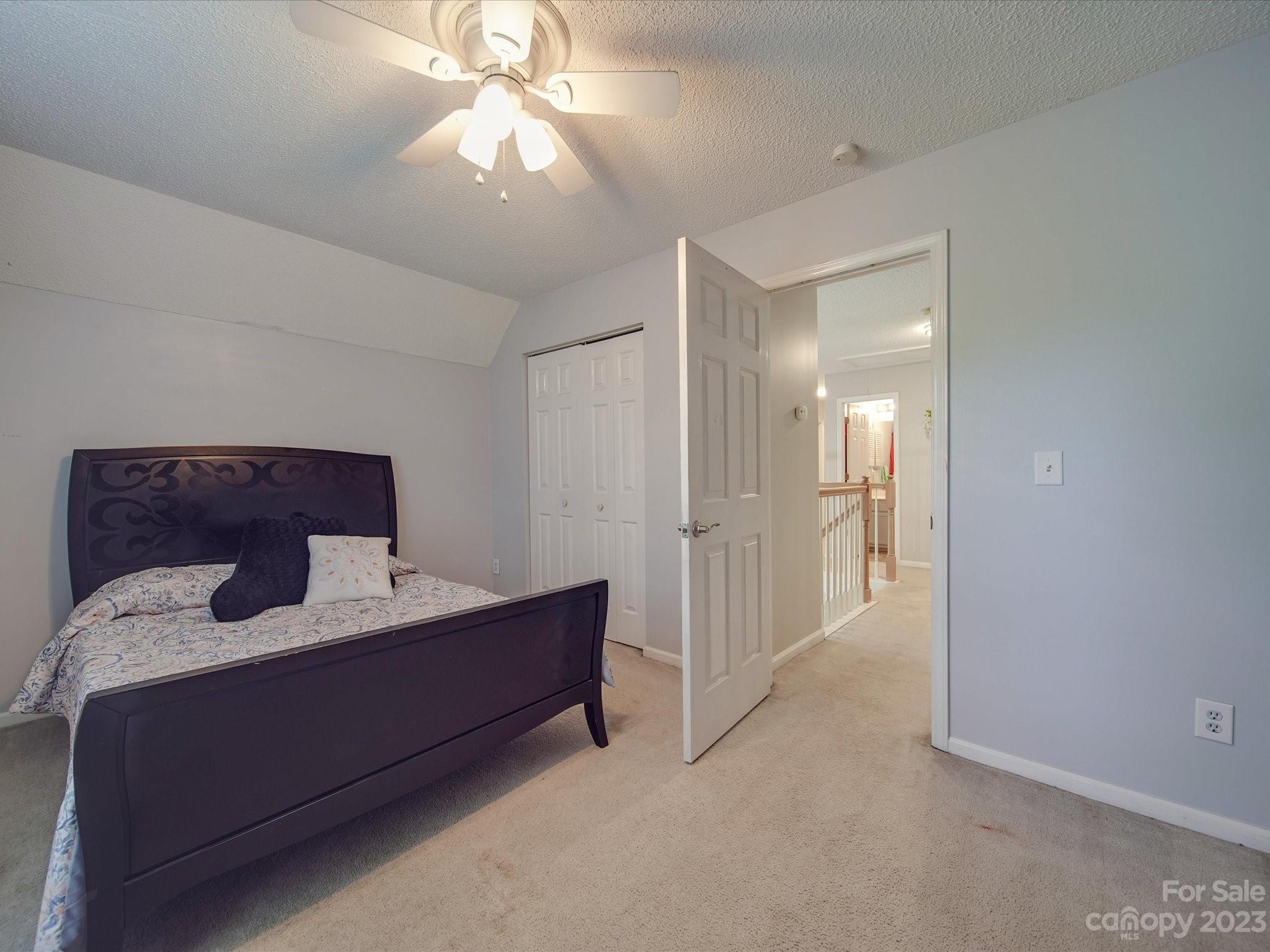 2349 Beaver Pond Road Kannapolis, NC 28083 - Photo 25 of 41 a bedroom with a bed and a chandelier