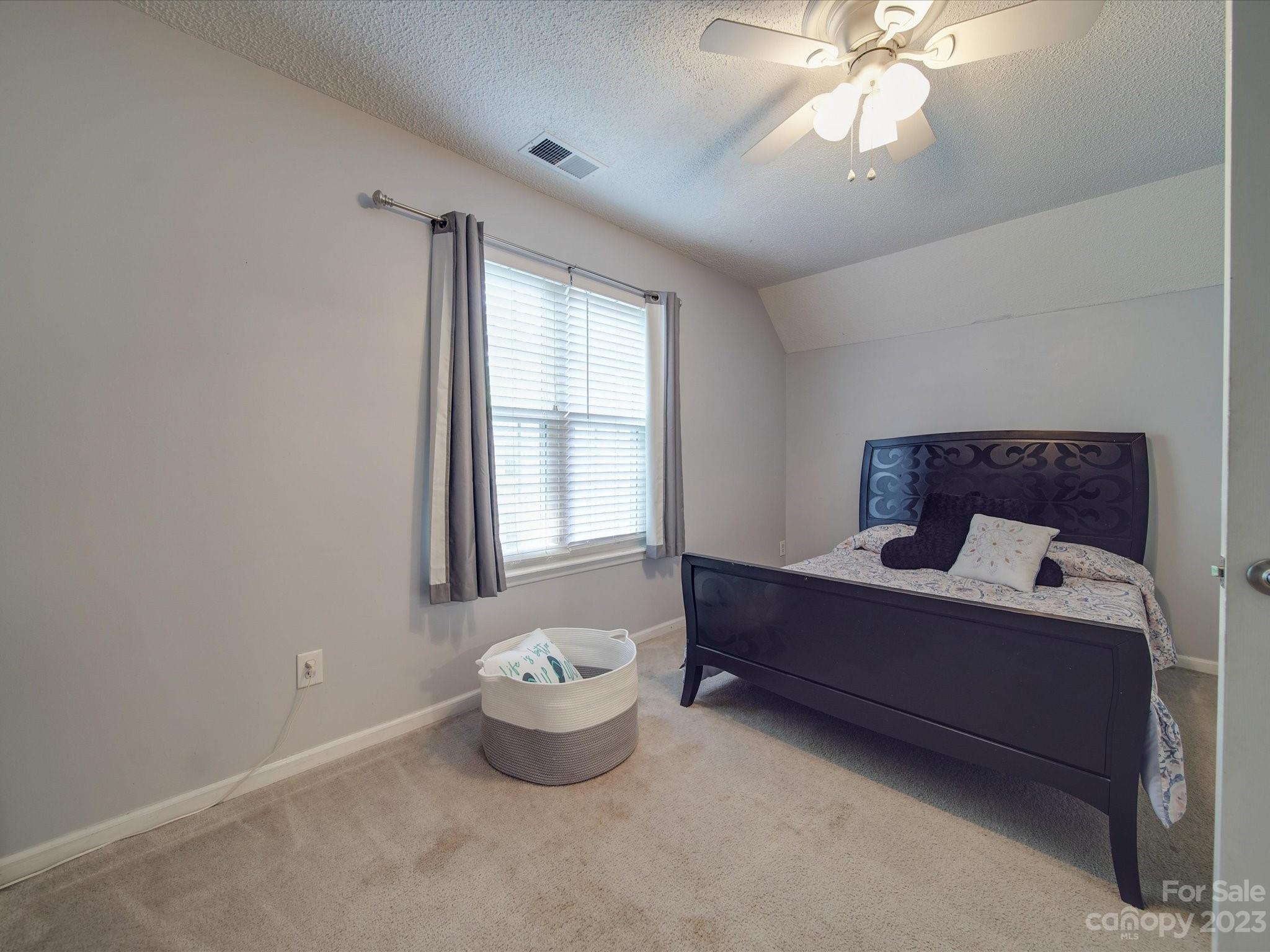 2349 Beaver Pond Road Kannapolis, NC 28083 - Photo 26 of 41 a room with a bed and a chandelier fan