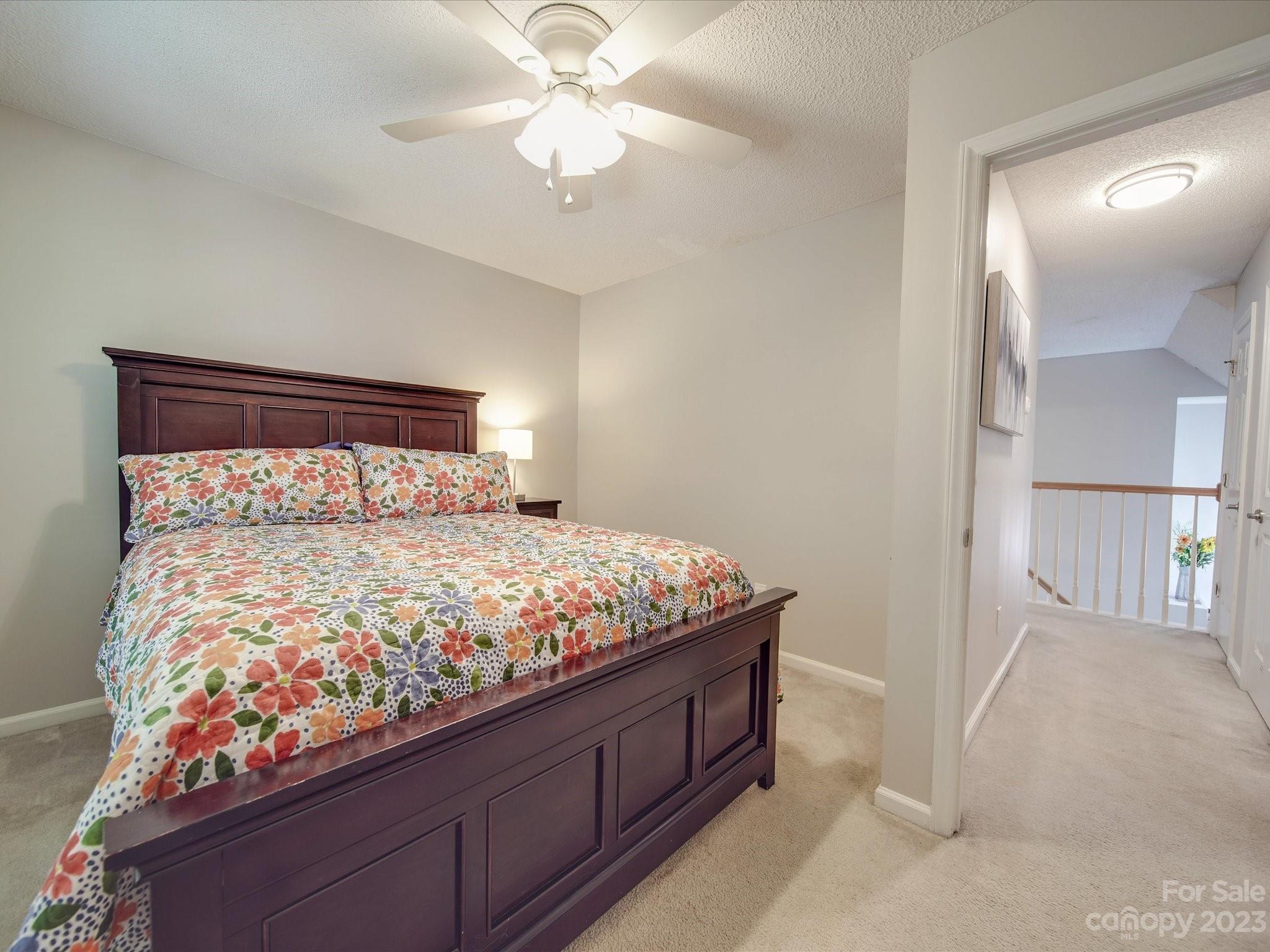 2349 Beaver Pond Road Kannapolis, NC 28083 - Photo 31 of 41 a bedroom with a bed and a chandelier