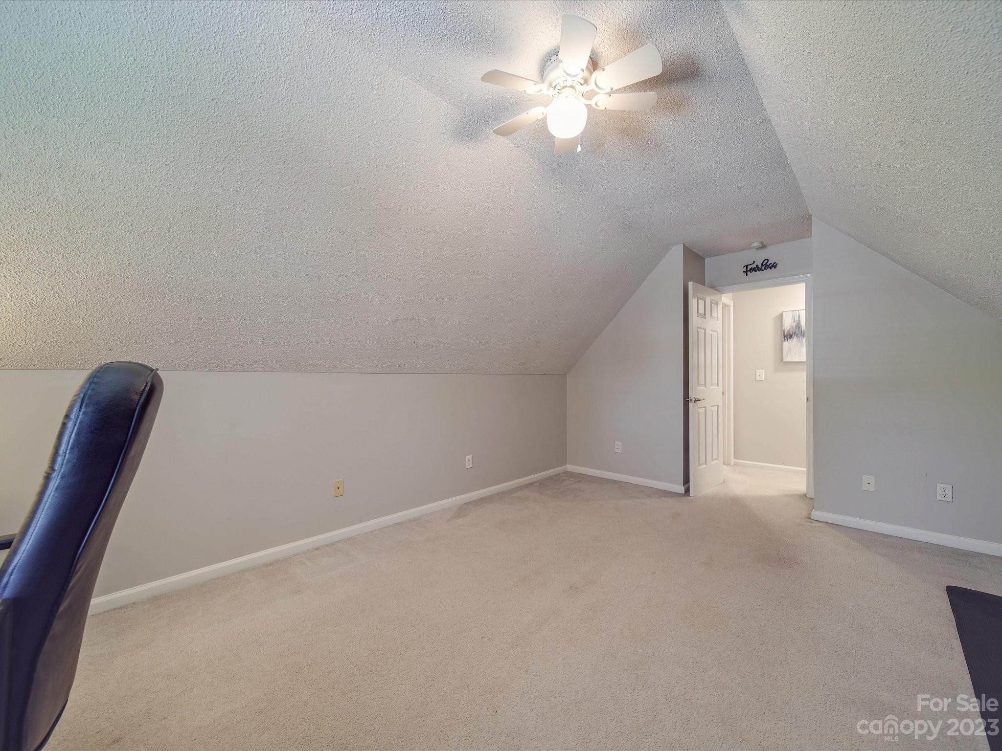 2349 Beaver Pond Road Kannapolis, NC 28083 - Photo 32 of 41 an empty room with a chandelier fan and a ceiling fan