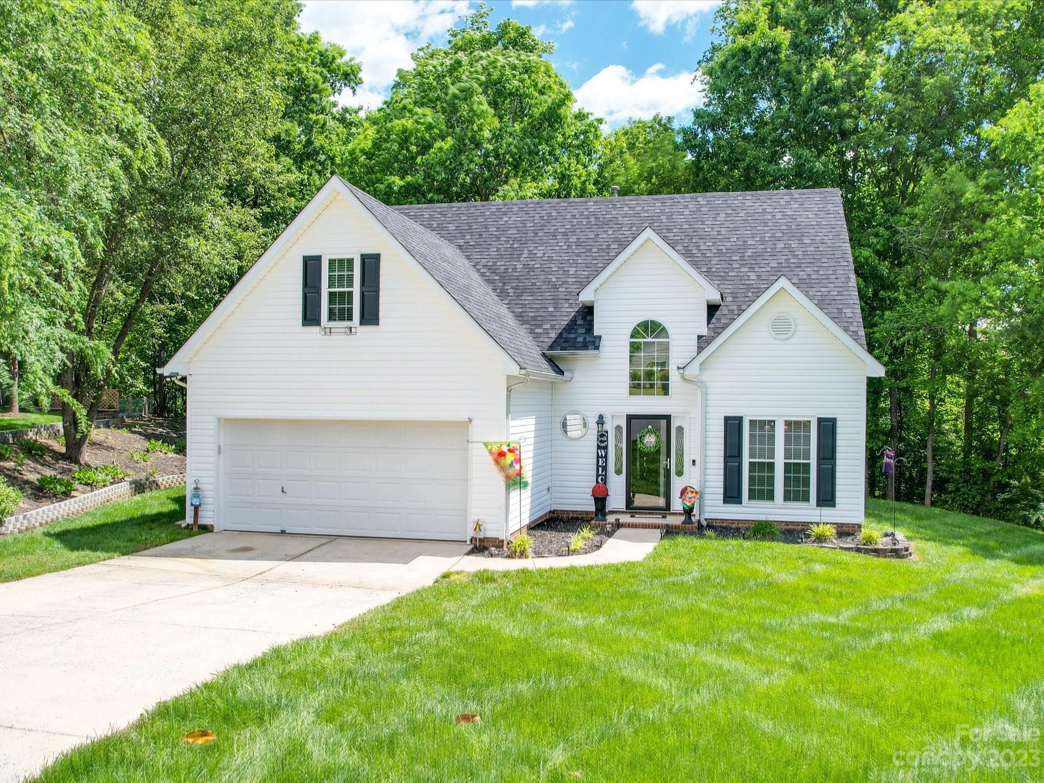 2349 Beaver Pond Road Kannapolis, NC 28083 - Photo 41 of 41 a view of a white house with a big yard and large trees