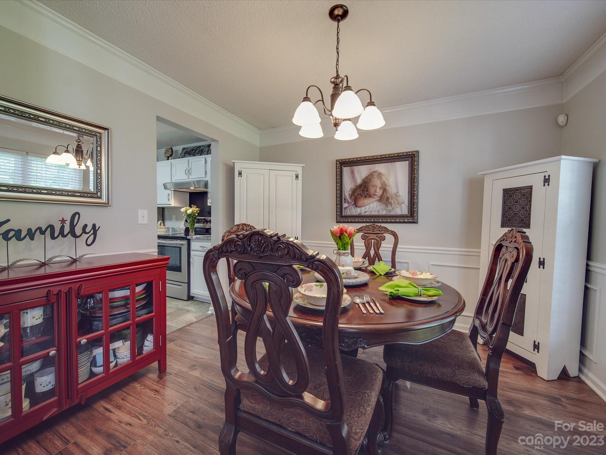 2349 Beaver Pond Road Kannapolis, NC 28083 - Photo 5 of 41 a view of a dining room with furniture wooden floor and chandelier