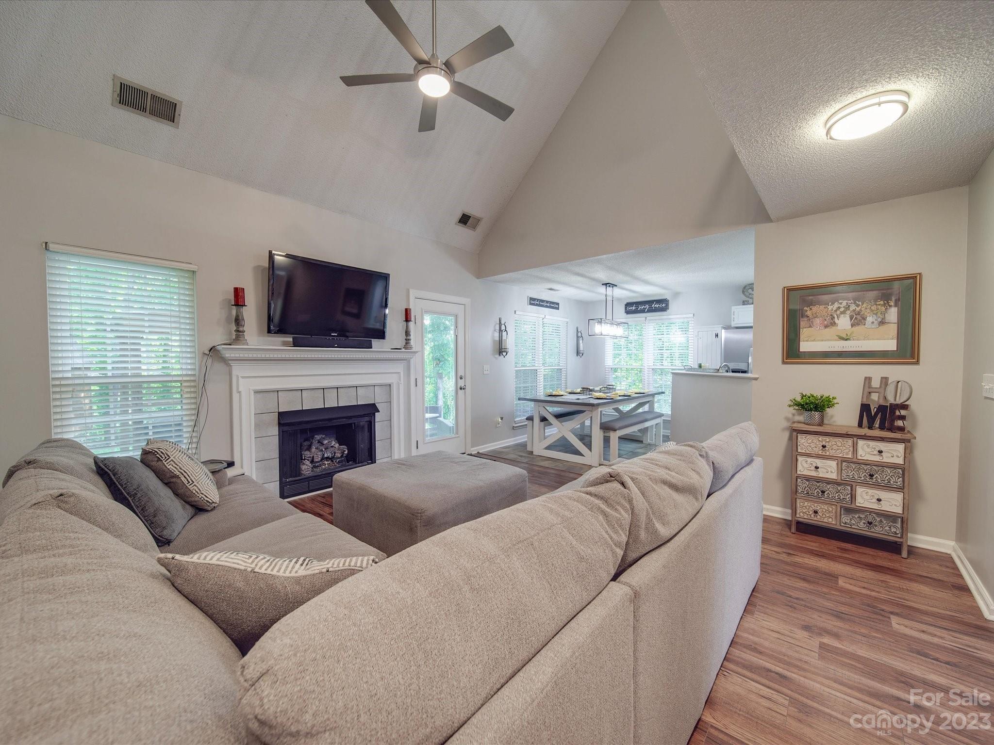 2349 Beaver Pond Road Kannapolis, NC 28083 - Photo 10 of 41 a living room with furniture a fireplace and a flat screen tv
