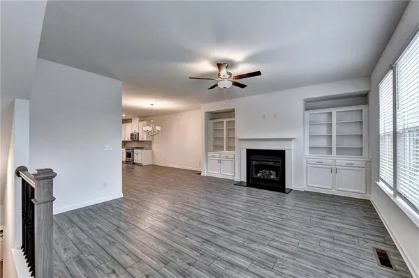 a view of a livingroom with a fireplace a fireplace and wooden floor