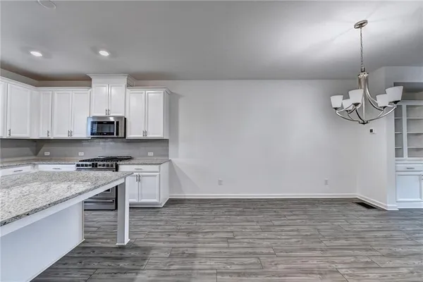 a kitchen with granite countertop a stove and a sink