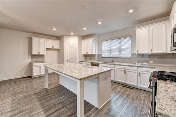 a kitchen with a sink window and cabinets