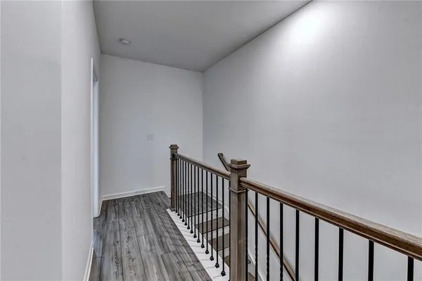 a view of a hallway with wooden floor