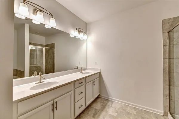 a bathroom with a double vanity sink and a mirror