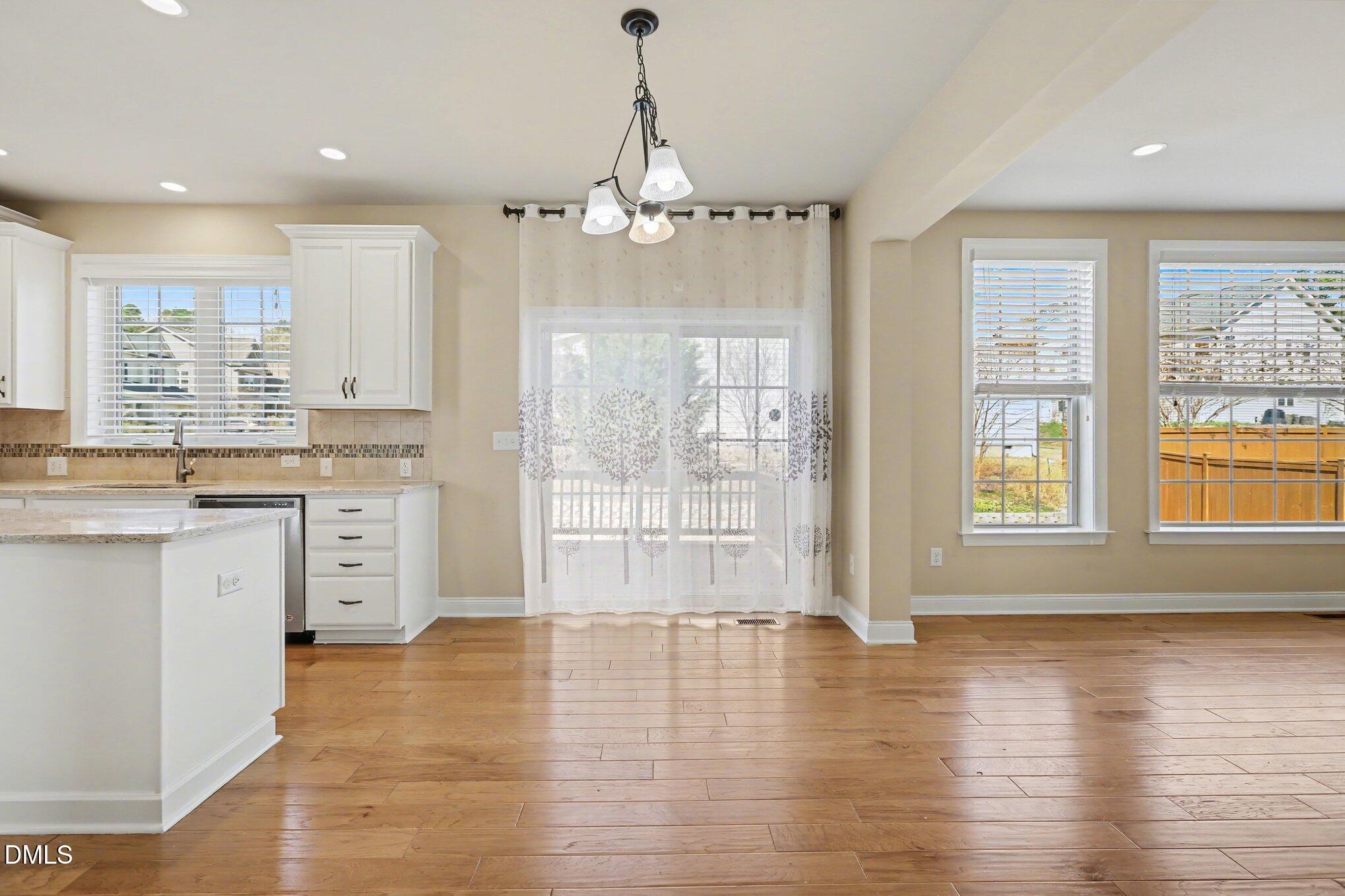 351 Gartrell Way Cary, NC 27519 - Photo 17 of 51 a view of a kitchen with kitchen island white cabinets and wooden floor