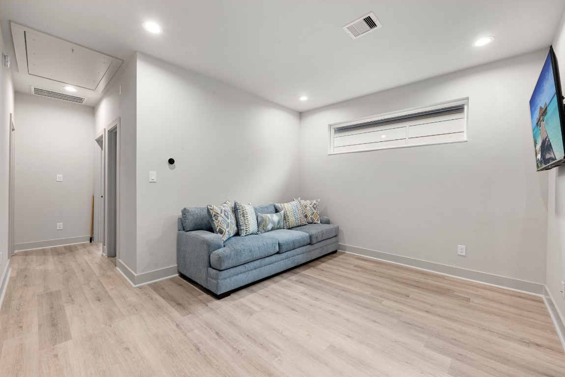 5722 Rucio Lane, Unit A Houston, TX 77092 - Photo 18 of 29 a living room with furniture and a wooden floor