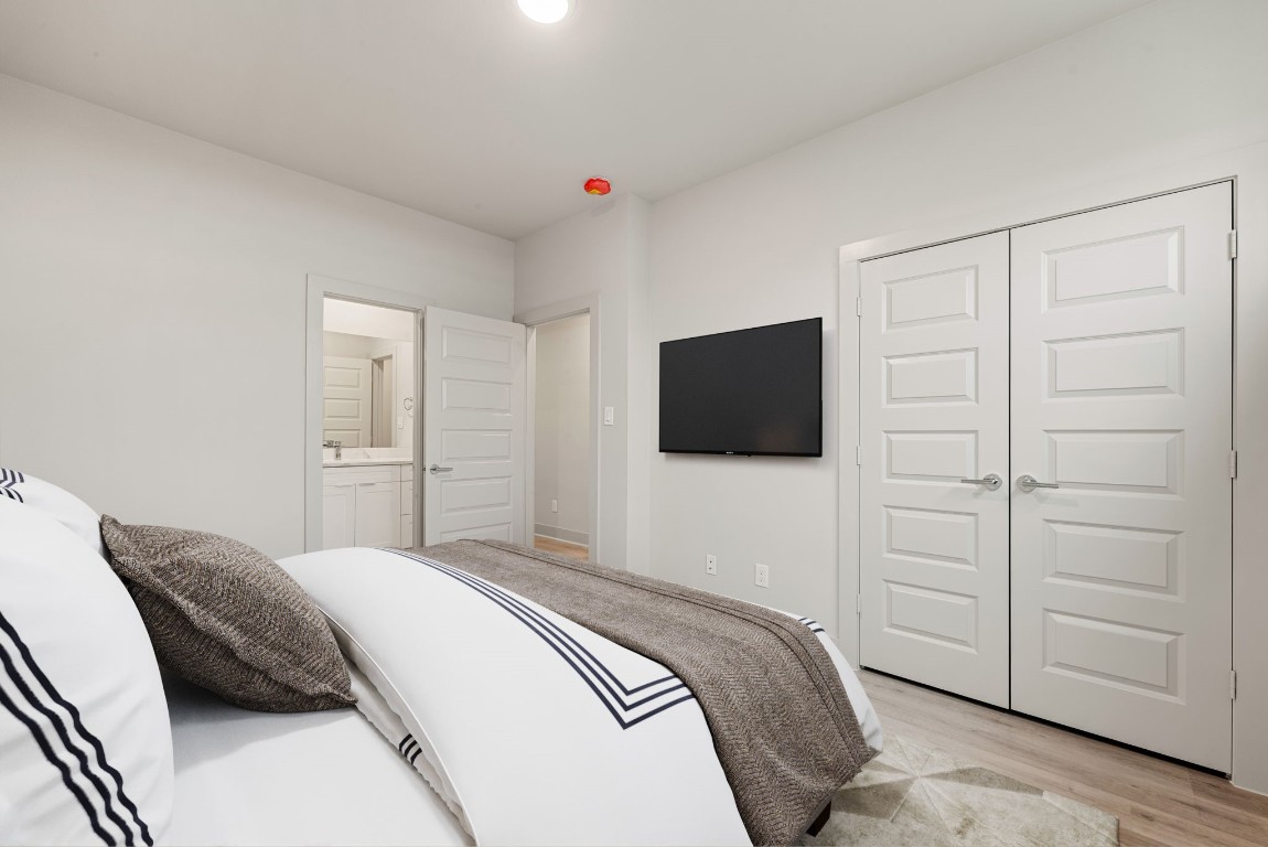 5722 Rucio Lane, Unit A Houston, TX 77092 - Photo 21 of 29 a bedroom with a bed and a television