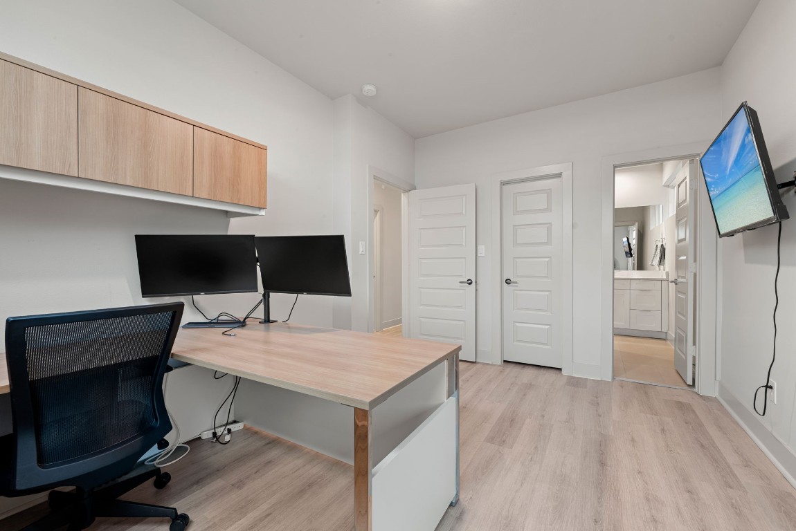 5722 Rucio Lane, Unit A Houston, TX 77092 - Photo 24 of 29 a view of a workspace with furniture and wooden floor