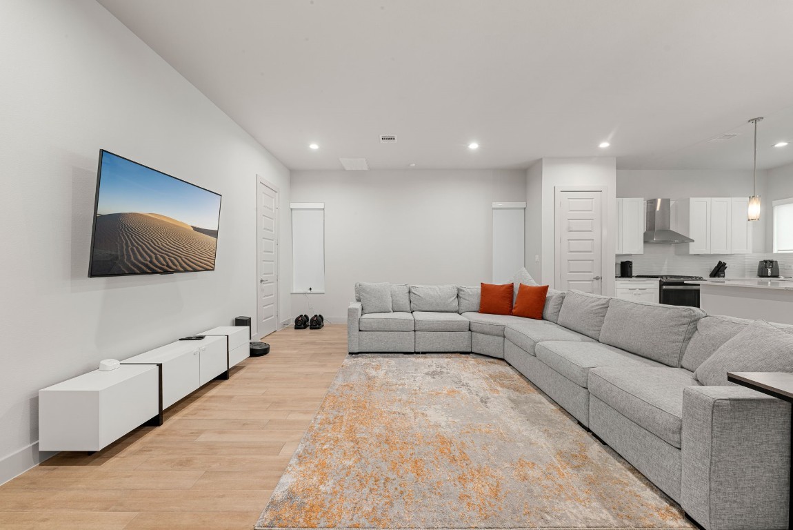 5722 Rucio Lane, Unit A Houston, TX 77092 - Photo 4 of 29 a living room with furniture and a flat screen tv