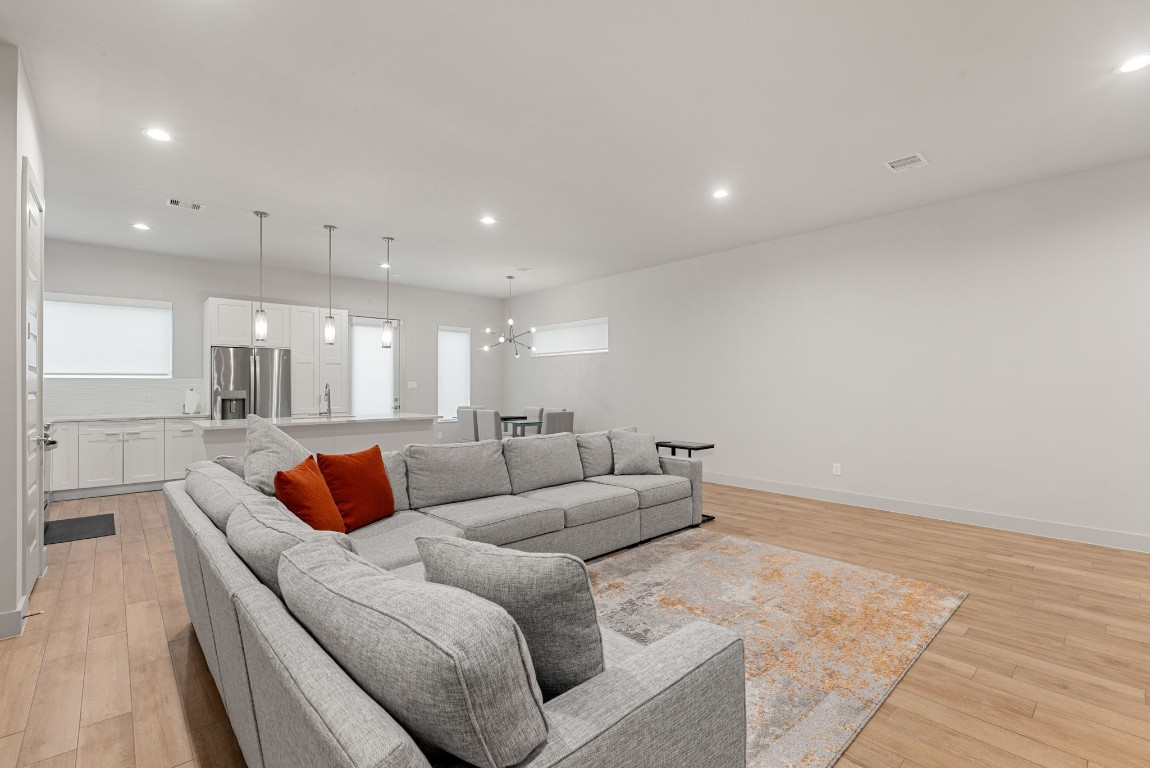 5722 Rucio Lane, Unit A Houston, TX 77092 - Photo 5 of 29 a living room with furniture and a large mirror
