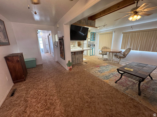 1225 North Dixie Downs Road, Unit 100 St. George, UT 84770 - Photo 4 of 22 Open-concept living area featuring a decorative ceiling fan, track lighting, and a built-in breakfast bar