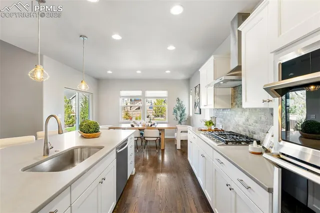 a kitchen with sink stove and cabinets