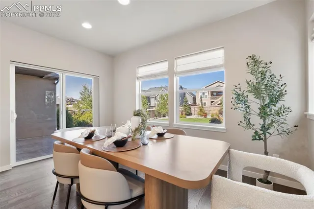 a dining room with furniture window and wooden floor