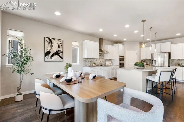 a kitchen with a table chairs sink and cabinets
