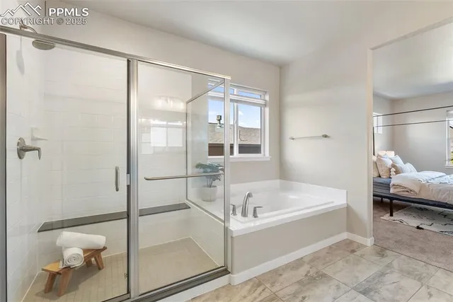 a white bath tub sitting next to a toilet