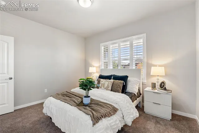 a bedroom with a bed and a potted plant