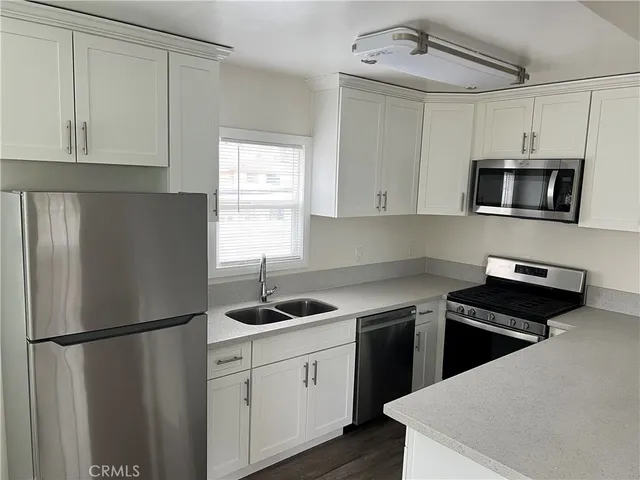 a kitchen with a refrigerator stove and microwave