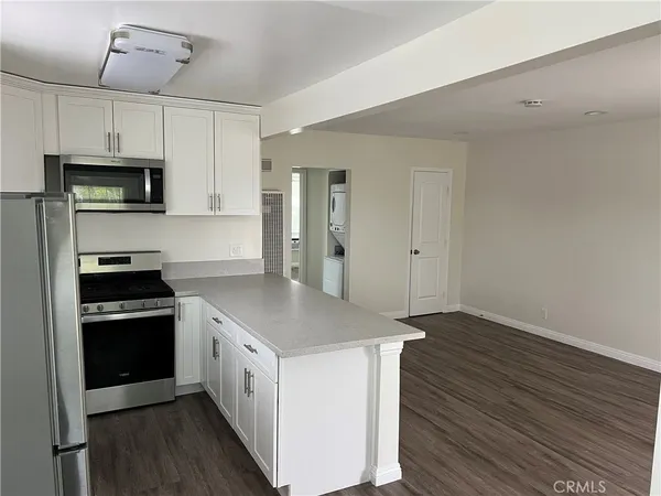 a kitchen with stainless steel appliances a white stove top oven and refrigerator