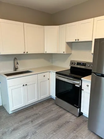 a kitchen with a sink stove and cabinets