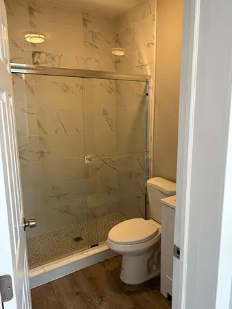 a bathroom with a toilet and a shower