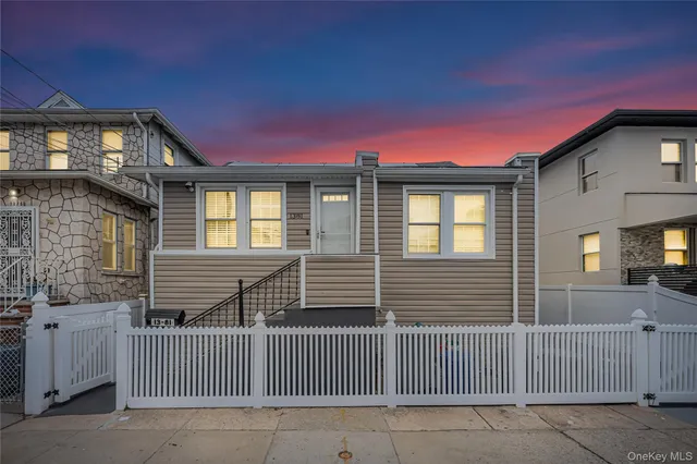 a front view of a house with iron fence