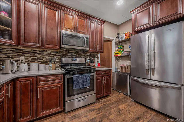 a kitchen with stainless steel appliances granite countertop a refrigerator stove and sink